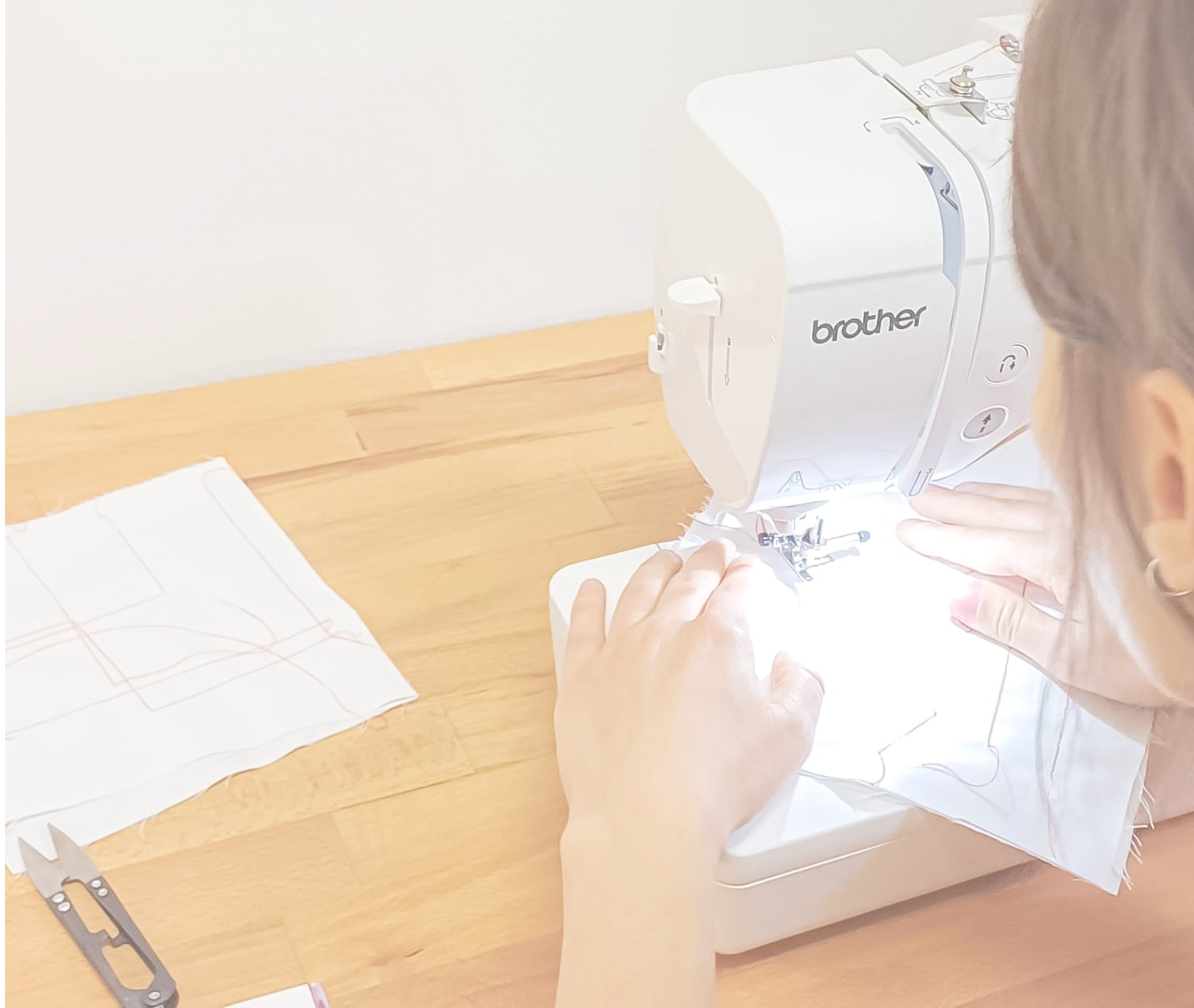 Picture of a woman sitting at a sewing machine