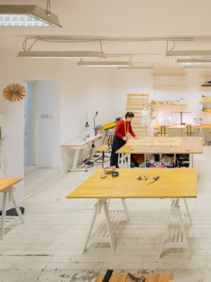 Shared sewing studio with cutting table and machines